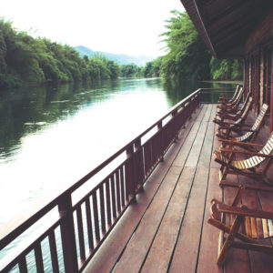 Wooden chairs in floating hotel on the River Kwai in Thailand